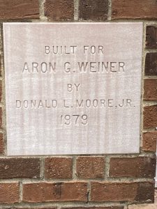Photo of a plaque showing the townhouses built by Aron Weiner